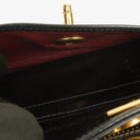 Pochette bracelet Chanel en cuir verni noir avec logo CC